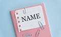 NAME text written on notepad on the blue background Royalty Free Stock Photo