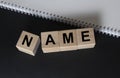 NAME word on cubes blocks on black and white background