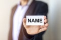 NAME word on paper in male hand in suit