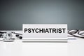 Nameplate With Psychiatrist Job Title Against Grey Background