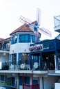 Namhae,South Korea-November 2020: Red brick roof house with wind turbine and blue fence at Namhae German Village, South Korea