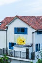 Namhae,South Korea-November 2020: Red roof with white wall with sunflowers mural at Namhae German Village, South Korea