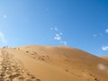 Namib desert on a hot summers day at Sossusvlei hiking up a sand dune Royalty Free Stock Photo