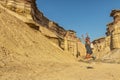 NAMIBE/ANGOLA 03NOV2018 - Young girl jumping in the middle of canyons of the Namibe Desert. Angola. Africa