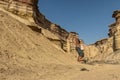 NAMIBE/ANGOLA 03NOV2018 - Young girl jumping in the middle of canyons of the Namibe Desert. Angola. Africa Royalty Free Stock Photo