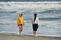 Namibia, Africa - June 14, 2021: Two women is walking by the beach at daytime Royalty Free Stock Photo