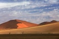 Namibia landscape. Big orange dune with blue sky and clouds, Sossusvlei, Namib desert, Namibia, Southern Africa. Red sand, biggest