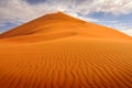 Namibia landscape. Big orange dune with blue sky and clouds, Sossusvlei, Namib desert, Namibia, Southern Africa. Red sand, biggest