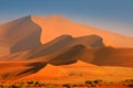 Namibia landscape. Big orange dune with blue sky and clouds, Sossusvlei, Namib desert, Namibia, Southern Africa. Red sand, biggest