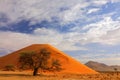 Namibia landscape. Big orange dune with blue sky and clouds, Sossusvlei, Namib desert, Namibia, Southern Africa. Red sand, biggest Royalty Free Stock Photo