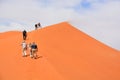 Namibia in Namib-Naukluft National Park People climbing the dune 45