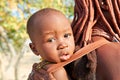 Namibia. Portrait of a Himba woman with her baby, in Kunene region