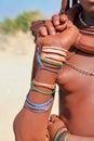 Namibia. Portrait of a Himba woman in Kunene region. Details of jewellery
