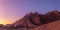 Namibia - Spitzkoppe - Panoramic view of rugged granite mountain range illuminated by soft evening light at sunset Royalty Free Stock Photo