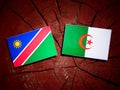 Namibian flag with Algerian flag on a tree stump isolated