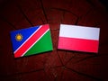 Namibian flag with Polish flag on a tree stump isolated