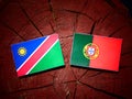Namibian flag with Portuguese flag on a tree stump isolated