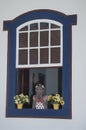 A Namoradeira, lover seraching wooden girl, on a window of Tiradentes, Minas Gerais, Brazil.