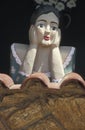 A Namoradeira, lover seraching wooden girl, on a window of Tiradentes, Minas Gerais, Brazil.