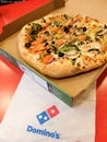 Big beautiful veggie pizza with a thick crust from DominoÃ¢â¬â¢s Pizza