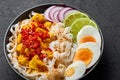 Nan Gyi Thoke in black bowl at dark slate background. Nan gyi Thohk is popular burmese cuisine dish