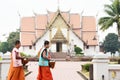 Thai Buddhist monks walking at front of Ubosot at Wat Phumin in morning time