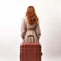 Nancy: A Stylish Woman With Reddish Hair And Suitcase