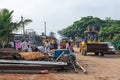 Dirt road with people sorting through rubble Nandakeshwar Karnataka India