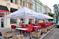 Outdoor street food restaurant with tables and gazebo where to eat traditional Belgian food and drink Belgian beer.