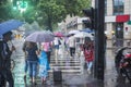 ItÃ¢â¬â¢s raining in the morning, and pedestrians walking through the road pass by the intersection.