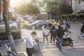 Sunset city scenery, pedestrians, traffic flow.