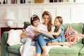 Nanny reads a book to children Royalty Free Stock Photo