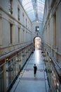 Unrecognizable person walking alone on the corridor of Galleries del Horologe