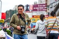 Nantong City / China Asia retired male tourist walking around in city with DSLR camera