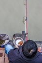 Nantong City / China - October 3, 2011 : Top down view of a Chinese man and fishing rod by the lake in city