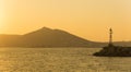 Naoussa in Paros island in Greece with a lighthouse during sunset. Royalty Free Stock Photo