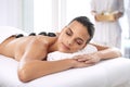 Nap, hot stone and woman with massage at spa for wellness, health and back treatment. Self care, cosmetic and young Royalty Free Stock Photo