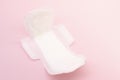 Sanitary napkin or sanitary pad for intimate hygiene on a pink background Royalty Free Stock Photo