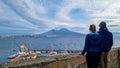 Naples - Couple at the Castel dell Ovo with view on the summit of mount Vesuvius in Naples, Italy, Europe Royalty Free Stock Photo