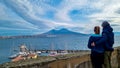 Naples - Couple at the Castel dell Ovo with view on the summit of mount Vesuvius in Naples, Italy, Europe Royalty Free Stock Photo