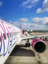 Big white purple and blue aeroplane of Wizzair on airport