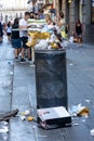 Naples, Italy - August 15, 2019: Overloaded trash can in Naples hitoric city center in summer