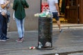 Naples, Italy - August 15, 2019: Overloaded trash can in Naples hitoric city center in summer