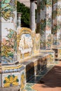 Colourful tiled pillars and bench in the cloister garden at the Santa Chiara Monastery in Via Santa Chiara, Naples Italy.