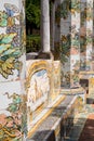 Colourful tiled pillars and bench in the cloister garden at the Santa Chiara Monastery in Via Santa Chiara, Naples Italy.