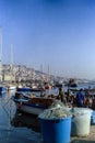 NAPLES, ITALY, 1988 - Fishermen moor their boats in the port of Mergellina and place their nets after a day of hard work