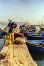 NAPLES, ITALY, 1988 - Fishermen moor their boats in the port of Mergellina and place their nets at the end of a fishing day