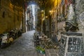 Narrow streets of the histrorical center, the traditional mask with face of Pulcinella in the old town of Naples, Campania, Italy