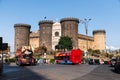 Castel Nuovo with tourist buses parked in front and clear blue sky Royalty Free Stock Photo