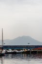 Circolo Canottieri Napoli, the Naples Rowing Club with boats on port and mountain in the background